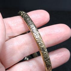 *Description: This is a great Whiting & Davis embossed gold tone floral bangle bracelet from the late 1960s to 1970s. The bracelet is in great condition and is signed on the inside of the bangle. This would be a great vintage bangle bracelet for your collection of Whiting & Davis and would also make a great gift. It would be the perfect bracelet to layer with other bangles. It is an over the hand bracelet, no clasp. *Approximate Measurements: Length - 7 1/2 Inches, Width - 1/4 Inch *Cond Amp Davis, Bangle Bracelet Gold, Formal Earrings, Vintage Bangle Bracelets, Book Pieces, Brass Bangle, Late 1960s, Vintage Bangles, Hand Bracelet