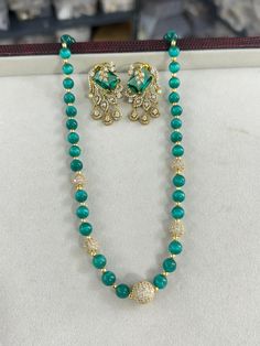 Add a touch of elegance to your jewelry collection with this stunning Emerald Bead Long Mala Necklace set, perfect for any special occasion or celebration. This exquisite piece of Indian and Pakistani jewelry features high-quality mala beads, carefully selected for their rich emerald color and lustrous shine. The necklace is adorned with sparkling Swarovski Kundan stones, creating a striking statement look. Accompanied by elegant CZ stud earrings, this set is ideal for weddings, parties, or trad Elegant Gemstone Beads For Parties, Elegant Crystal Faceted Beads, Elegant Beaded Necklace For Festive Season, Elegant Faceted Crystal Beads, Elegant Festive Beaded Necklaces, Festive Elegant Beaded Necklaces, Elegant Festive Round Beaded Necklaces, Festive Round Beaded Elegant Necklace, Festive Elegant Round Beaded Necklaces