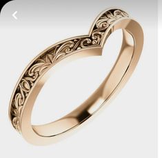 an intricately designed wedding band in yellow gold