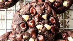 chocolate cookies with nuts on top cooling on a rack