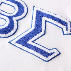 White shirt Chenille embroidered logo True to size Blue College T-shirt With Embroidered Logo, White Embroidered T-shirt For College, Varsity T-shirt With Letter Embroidery For College, Varsity T-shirt With Letter Embroidery, Cotton T-shirt With Letter Embroidery For College, Sporty T-shirt With Embroidered Text For College, White Letter Embroidery T-shirt For Streetwear, Varsity Cotton T-shirt With Embroidered Graphics, White Embroidered Graphics T-shirt For College