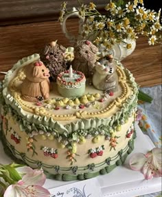 there is a cake decorated with animals and flowers