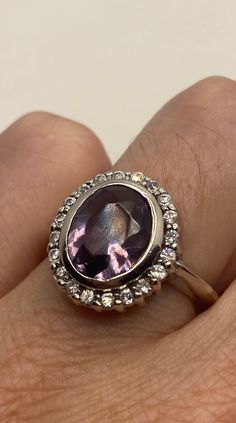 This is a vintage purple amethyst with amethyst sidestones set in 925 sterling We have in size 7 this can be sized to your specification, our jeweler charges $10-$20 please message us to discuss sizing your ring or engraving options. All of our jewelry is hand polished and shipped to you in a stylish gift box. We are happy to gift wrap for you. It is important to us that each customer be thrilled with their purchase. We are grateful for thousands of positive reviews. Dazzling Amethyst Ring As A Gift, Dazzling Amethyst Ring Gift, Dazzling Amethyst Gift Ring, Purple Jewelry For Formal Occasions, Vintage Amethyst Ring With Accent Stones For Anniversary, Antique Purple Amethyst Ring With Accent Stones, Elegant Sterling Silver Amethyst Ring, Round Sterling Silver Amethyst Ring, Vintage Purple Amethyst Ring For Anniversary