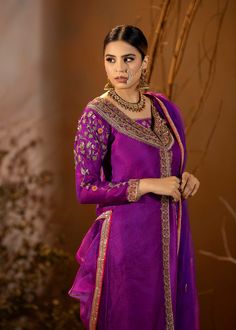 Introducing our stunning Purple Organza Outfit! This elegant dress is adorned with intricate details, featuring beautiful embroidery and embellishments. The rich purple color adds a regal touch, and it comes with a chooridar pajama for a complete look. Perfect for making a statement at special occasions! Purple Silk Sharara For Navratri, Purple Anarkali Set With Straight Kurta And Dabka Work, Purple Chanderi Sharara For Navratri, Purple Chanderi Sharara With Traditional Drape, Semi-stitched Purple Sharara With Resham Embroidery, Traditional Purple Sharara For Festive Occasions, Navratri Purple Sharara With Straight Kurta, Bollywood Purple Raw Silk Sharara, Bollywood Style Purple Raw Silk Sharara