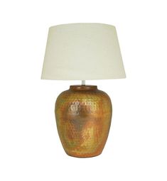 a table lamp with a white shade on it's base and a gold textured finish