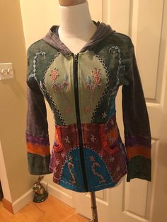 Very cool hoodie with patchwork and embroidery design long sleeve with full zip, this is an awesome hoodie in excellent condition on all accounts. Tag is too faded to see size,Im saying Small to Med, measurements shown in pics, all cotton, very soft.  price includes shipping. Multicolor Cotton Hoodie For Winter, Cotton Hoodie With Patchwork, Multicolor Hooded Hoodie With Pockets, Fall Patchwork Hoodie Jacket, Fall Hooded Patchwork Jacket, Fall Patchwork Hooded Jacket, Multicolor Long Sleeve Hoodie With Drawstring, Casual Patchwork Hooded Jacket, Cotton Patchwork Hooded Outerwear