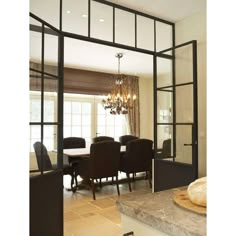 a dining room table with chairs and a chandelier