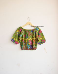 HarmonyHandicraftCo represent you a beautiful Banjara Top. Make your look more stylish by wearing this Banjara top.  Hand embroidery top with inside lining fabric. Banjara Top, Hand Embroidery Top, Indian Style Top, Indian Handmade Top, Banjara Kuchi Top, Hand Embroidery Choli, Banjara Choli. MEASUREMENTS :  Length - 17.5 Inches Chest - 42 Inches Inside lining Fabric FABRIC 100 % Hand Embroidered Could be used for Party, Birthday , Vacations Etc. Selling it at unbeatable price!! Wash Care - Mach Bohemian Tops With Floral Embroidery For Navratri, Summer Festival Embroidered Choli, Embroidered Bohemian Choli For Summer, Bohemian Embroidered Top For Navratri, Bohemian Unstitched Blouse Tops For Navratri, Summer Multicolor Choli With Floral Embroidery, Bohemian Unstitched Blouse For Navratri, Summer Bohemian Embroidered Choli, Bohemian Green Tops For Festivals