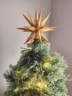 a christmas tree with an origami star on top