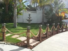 a fence with rope around it in front of a house