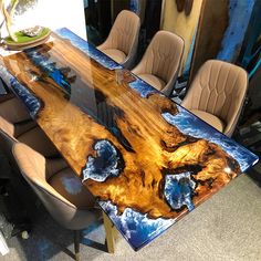 the table is made out of wood and has an artistic design on it's surface