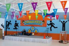 an indoor stage set up with colorful flags and decorations