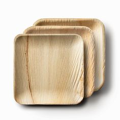 three square wooden plates sitting on top of each other