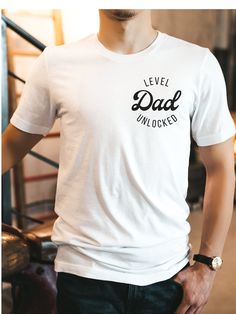 "The \"Dad Level Unlocked\" t-shirt is a fun and playful way for dads and soon-to-be dads to show off their fatherhood achievements. The text is a nod to the popular gaming culture phrase \"level unlocked,\" and highlights the new level of responsibility and joy that comes with becoming a dad. This t-shirt makes a great gift for Father's Day, birthday, or for a baby shower/baby announcement!  Bella + Canvas Brand Shirt ▶Unisex Adult Sizing ▶See Our Size Chart For Proper Sizing ▶For an oversized look, go 1-2 sizes up! ▶Rolled sleeves are for styling purposes only ▶Props used in photos are not included with the purchase ▶Please note that the colors of the design on the T-shirt may      appear slightly different due to variations in monitor settings. ✈ PROCESSING & SHIPPING ✈ Processing Time: Dad To Be Shirt, Your Going To Be A Dad Surprise, Dad Pregnancy Announcement, Unique Pregnancy Announcement, Expectant Father, Delivering A Baby, New Dad Gift, Dad To Be, Father Shirts