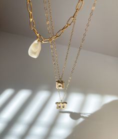 An edgy, yet classic piece that can easily be worn by itself to complete a look. Dress it up or dress it down. This necklace is 15.5 inches long. This is made with a cultured pearl and gold filled materials. It is safe to wear in water, but should stay away from chemicals like soaps, lotions, and perfumes. Minimalist Gold Pearl Necklace With Chain, Everyday Gold-plated Chain Necklace With Pearl Pendant, Gold Plated Pearl Necklace For Everyday, Everyday Gold Plated Chain Necklace With Pearl Pendant, Everyday Gold Plated Pearl Necklace, Everyday Metal Necklace With Pearl Charm, Everyday Gold Pearl Charm Necklaces, Gold-tone Necklace With Pearl Drop For Gift, Gold Pearl Necklace With Pearl Charm For Everyday