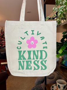 -Hand-painted canvas tote bag -Six pockets! Length: 13 3/4" Width: 13 1/4" Thickness: 6 1/2" Handle Drop Length: 10" Painted Tote Bag Ideas, Tote Bag Sayings, Bag Sayings, Painted Tote Bag, Cultivate Kindness, Tote Bag Ideas, Painted Tote, Trendy Tote Bags, Custom Ideas