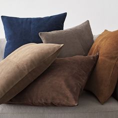 pillows stacked on top of each other on a couch