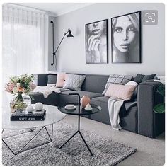 a living room filled with furniture and pictures on the wall above it's coffee table