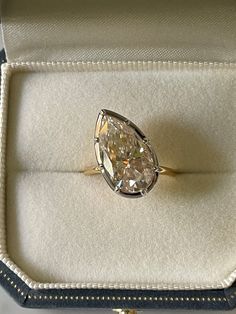 an oval cut diamond sits in a box