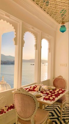 an ornately decorated dining room overlooks the ocean