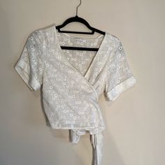 Gorgeous White Linen Top. Can Be Tied Several Different Ways With Very Long Ties As Shown In Picture. Looks Gorgeous On, Super Flattering. Sheer Material, So Need To Wear Cami Bralette Under! Cuff Sleeved Detail As Well! Size Shown Is A Eu 38 Which Translates To A 10 Or 12 American. Fits Like A L/Xl. New Without Tags, Never Worn! Spring Vacation Tops With Tie Waist, Summer Top With Tie Waist For Brunch, Spring Beach Tops With Tie Waist, Wrap Top With Tie Waist For Brunch, Spring Chic Crop Top With Tie Waist, Chic Spring Crop Top With Tie Waist, Summer Tie Waist Blouse For Day Out, Chic Wrap Top For Vacation In Spring, Chic Spring Wrap Top With Tie Waist