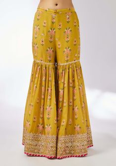 This pretty ensemble in our floral jaal, with an intricate border embroidery. The short tunic with matching dupatta embroidered in sequins and gold thread, and voluminous sharara adds a feminine grace. Designer Yellow Chikankari Embroidery Palazzo Set, Designer Yellow Palazzo Set With Chikankari Embroidery, Semi-stitched Yellow Palazzo Set With Floral Embroidery, Festive Chanderi Sharara With Floral Embroidery, Bohemian Chanderi Sharara For Eid, Yellow Anarkali Set With Floral Embroidery, Traditional Drape Sharara With Floral Embroidery For Eid, Designer Chanderi Sharara With Floral Embroidery, Bollywood Style Saree Palazzo Set With Floral Embroidery