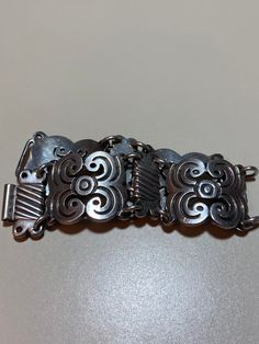 "This is a stunning, vintage, handmade Taxco sterling silver bracelet that has a beautiful, ornate Art Nouveau feel to it. The bracelet is about 8 inches. It is very hard to find these gorgeous Taxco bracelets in larger sizes like this one. It is very well-made and is about 1 1/8\" in width. It has an older style sterling silver hook clasp. The bracelet weighs a hefty 73.6 grams. It is stamped Mexico 925 with a faded Taxco hallmark/logo. Very pretty and well-made. See pictures for details. More Vintage Colombia, Hallmark Logo, Mexican Vintage, Mexican Jewelry, Older Style, Sterling Bracelets, Silver Chain Style, Older Fashion, Southwestern Jewelry