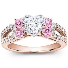 a heart shaped diamond ring with pink and white stones