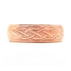 a rose gold wedding band with an intricate design