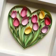 a paper heart with flowers cut out of it in the shape of a flower arrangement