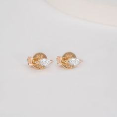 Marcia Embrace timeless design with a modern twist. These captivating 14k yellow gold stud earrings feature stunning marquise-cut diamonds, meticulously crafted to maximize their brilliance. The elongated marquise shape, also known as the "navette" or "eye" shape, flatters the face and adds a touch of sophisticated drama to any ensemble. - Handmade- Solid Gold- Natural Diamonds - G Color, SI Quality Diamonds- Total Diamond Carat Weight: 0.12 ctw- Dimensions of Setting: 5 x 2 mm All pieces come b Classic Marquise Diamond White Earrings, Classic Marquise Diamond Cut Earrings, Classic Marquise Diamond Earrings With Accents, Luxury Marquise Diamond Earrings For Anniversary, Gold Marquise-cut Diamond Earrings For Anniversary, Gold Marquise Cut Diamond Earrings For Anniversary, Gold Marquise Brilliant Cut Diamond Earrings, Marquise Diamond Earrings With Prong Setting For Anniversary, Gold Marquise Diamond Earrings With Brilliant Cut