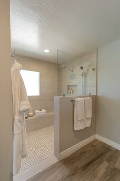 a bathroom with a walk in shower next to a sink