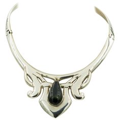 This stunning necklace has a modernist design in the center with a pear shaped rainbow obsidian in the center. It is hinged on both sides and closes with a push in clasp at the back. The collar's inside measurement is approximately 14.5". The ornament area measures 2.72" across by 1.82" tall. Marked Mexico TD-27 925 Alicia de la Paz Biography from Novica: "I was thrust into the realm of jewelry-making and soon enough the Mexican government awarded us... the prestigious national quality distincti Rainbow Obsidian, Modernist Design, When I Get Married, First Daughter, Art Contest, Stunning Necklace, Collar Necklace, State Art, Mexico City