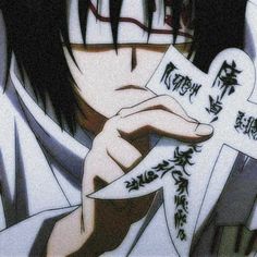 an anime character holding a cross with writing on it