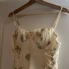 a dress hanging on a wooden hanger