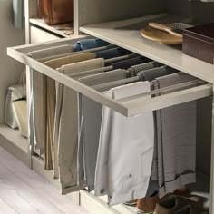 an organized closet with folded clothes and shoes