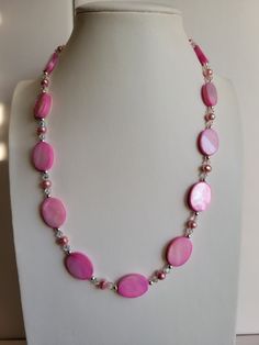 "The oval Mother-of-Pearl beads in this necklace are bright pink. It has clear ab Swarovski crystal beads and pink Freshwater pearls. The findings and remaining beads are sterling silver. It is 19.5\" long and has a 1\" extension with a beaded drop making it adjustable. Custom Orders are always welcome!" Pink Pearl Necklace With Colorful Beads As A Gift, Pink Pearl Beaded Necklaces With Gemstone Beads, Pink Pearl Necklace With Gemstone Beads, Pink Pearl Jewelry With Gemstone Beads, Pink Pearl Necklace With Faceted Beads As Gift, Elegant Pink Oval Beaded Necklaces, Pink Faceted Beaded Round Necklace, Pink Polished Bead Pearl Necklace For Gifts, Pink Pearl Necklace With Colorful Round Beads