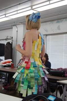 a woman in a dress made out of sticky notes