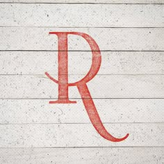 the letter r is painted red on wood