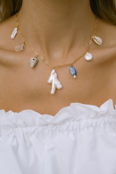 Our Mana necklace is your summertime vacay staple. Drift away to palm lined beaches, collecting shells, balmy summer nights & midnight swims. Paired beautifully with fresh sun-kissed skin & your favorite all white outfit. - 18k gold filled chain - Hand selected luminous freshwater baroque pearls - Lapis Lazuli - Quartz crystal - Mixed shells - Gold filled wire - Approx 16 inches end to end Gold filled jewelry is easily 100 times thicker compared to common gold plating & lasts just li Beachy Summer Necklaces For Beach Party, Summer Beach Party Necklaces, Vacation Pearl Charm Strand Necklace, Handmade Necklaces For Summer Beach Parties, Dainty Strand Jewelry For The Beach, Dainty Strand Jewelry For Beach, Dainty Strand Beach Jewelry, Vacation Strand Necklace With Pearl Charm, Beachy Jewelry For Beach Party