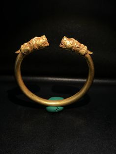 A Beautiful Old Bracelet Of Gold At The Two Ends Decorated With Tiger Head Figure Symbolize Might Strength. Worn For Protection and prosperity Good patina on the surface and certification of gold available On Request Of Customer Great quality and excellent collection Gold Collectible Bracelet, Unique Ceremonial Gold Jewelry, Unique Gold Jewelry For Ceremonial Occasions, Unique Gold Jewelry For Rituals, Luxury Carved Gold Jewelry, Ceremonial Gold Bracelet With Intricate Design, Spiritual Ceremonial Bracelet Jewelry, Unique Yellow Gold Brass Bracelet, Ceremonial Bronze Bangle Bracelets