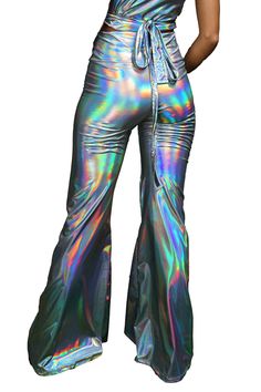 Step into the future with our mesmerizing holographic silver bell bottoms, a dazzling fusion of retro charm and futuristic allure. These eye-catching disco flares are crafted to captivate, boasting an otherworldly shine that transforms every movement into a hypnotic show. Designed with both style and comfort in mind, these pants feature a figure-hugging fit that seamlessly transitions into a dramatic flare, flattering all body shapes and sizes. More than just a piece of clothing, these pants are Trendy Shiny Party Bottoms, Trendy Shiny Bottoms For Party, Metallic Shiny Summer Pants, Metallic Shiny Pants For Summer, Disco Flare Party Bottoms, Disco Flare Bottoms For Party, Disco Flare Pants For Party Season, Disco Style Flared Party Bottoms, Spring Disco Club Bottoms