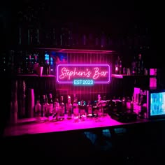 a bar with neon signs and liquor bottles