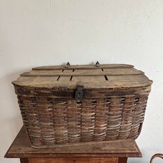 an old wooden basket sitting on top of a table