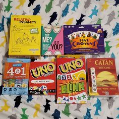 four children's board games laid out on a bed