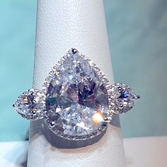 a diamond ring with three pear shaped diamonds on it