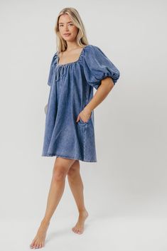 The Morgan Mini Dress is a summer essential -- she's quirky, on-trend, and (thanks to her 100% cotton construction), incredibly comfortable. We love how easy it is to dress this mini up with wedges and accessories, or dress it down with tennies or slides for a day of shopping or sightseeing. You don't want to miss out on this unique addition to your closet! FIT: Runs true to size - relaxed fit. MATERIAL: 100% Cotton. GARMENT DETAILS: Cotton denim mini dress with a swing silhouette and square, el Dark Wash Cotton Mini Denim Dress, Dark Wash Cotton Denim Mini Dress, Dark Wash Mini Denim Dress, Chic Washed Mini Dress, Cotton Mini Dress Medium Wash, Trendy Light Wash Mini Dress For Day Out, Spring Mini Dress Relaxed Fit For Daywear, Relaxed Fit Mini Dress For Summer Day Out, Short Sleeve Cotton Denim Dress For Day Out