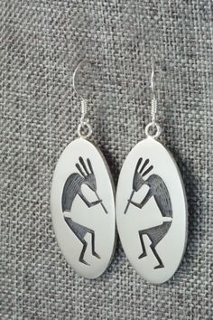 These Kokopelli sterling silver earrings are made by Hopi silversmith Timothy Mowa. The backs are signed and stamped sterling.Length: 1 3/4"Width: 5/8"Free shipping on all orders! We ship with USPS and always include tracking. All orders ship within a day of payment.Returns are accepted up to 30 days after you receive your order. Just send us a message. Our shop offers cash back or store credit. The item must be returned in new condition. Artisan Sterling Silver Etched Earrings, Artisan Etched Sterling Silver Earrings, Etched Sterling Silver Dangle Earrings, Silver Symbolic Engraved Earrings, Silver Engraved Symbolic Earrings, Symbolic Engraved Silver Earrings, Unique Silver Etched Earrings, Unique Etched Silver Earrings, Oval Southwestern Sterling Silver Earrings