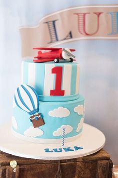 a birthday cake with an airplane and hot air balloon on top