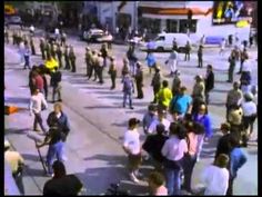 a crowd of people walking across a street